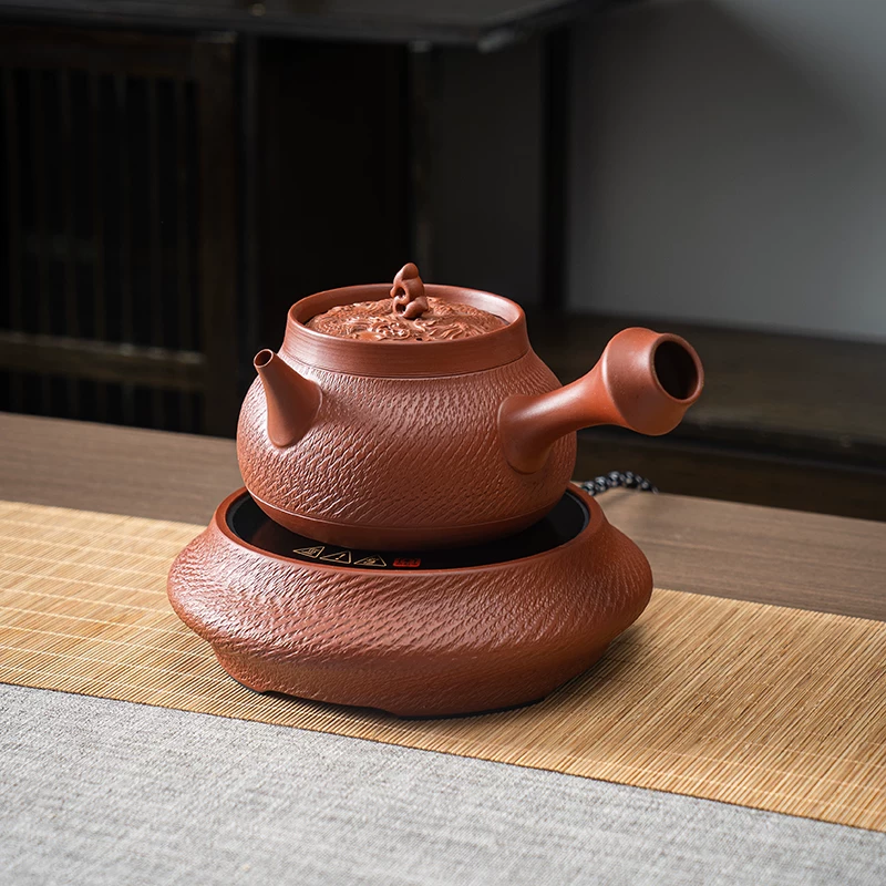 Carved teapot on electric warmer