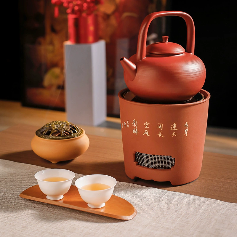 Lifted-handle teapot on warmer with cups